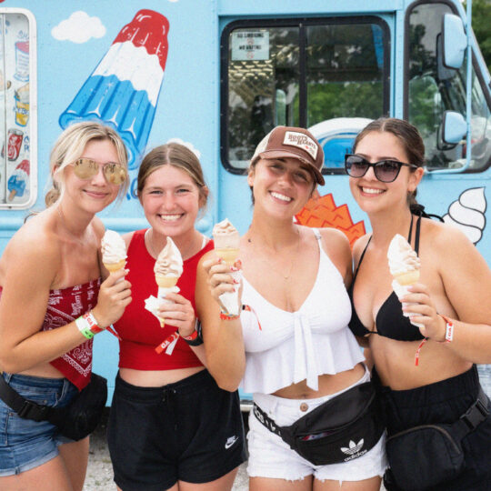 Fans enjoying ice cream from a festival food truck.